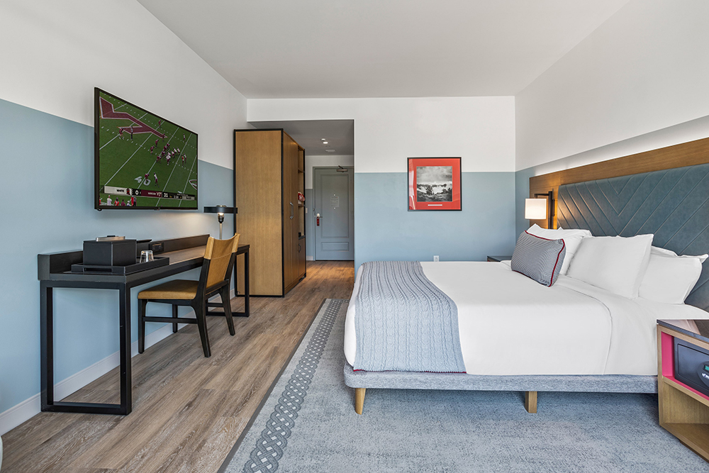 The Tartan King Room at The Highlander Hotel Radford featuring a king-size bed, modern furnishings, a seating area, and a work desk.